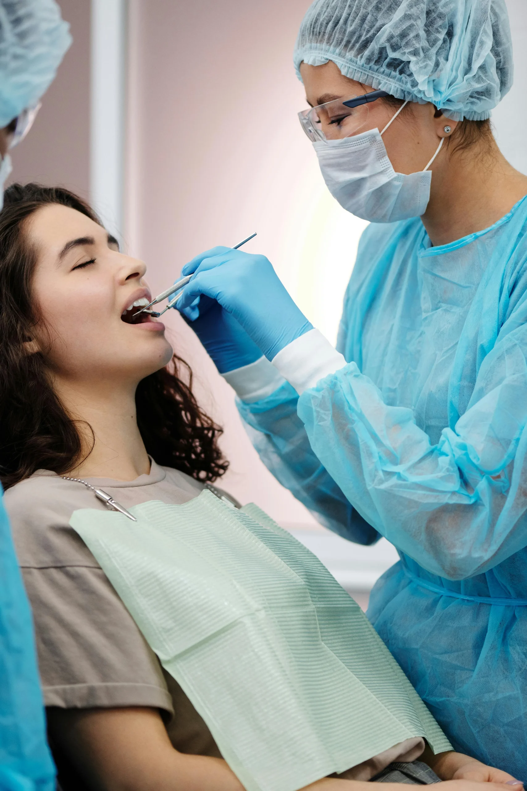 Female dentist examining patient's teeth in a dental clinic